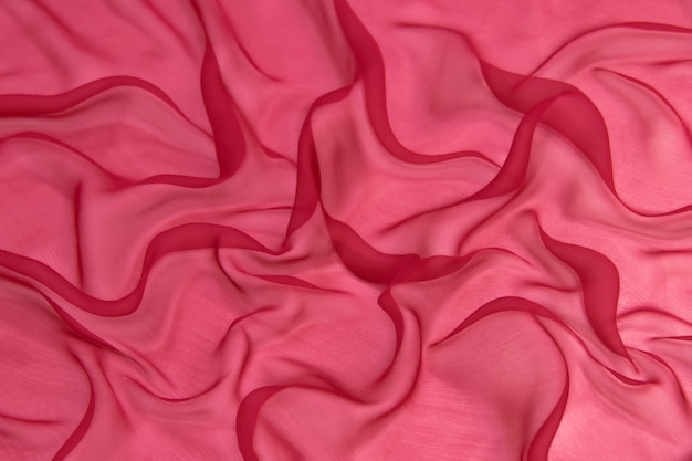 Abstract pink color silk chiffon fabric texture background.