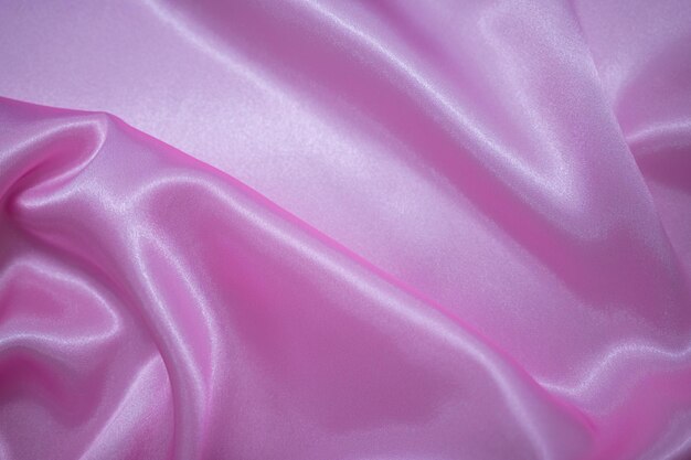 Abstract pink Satin Silky Cloth Fabric Textile Drape with Crease Wavy Folds background