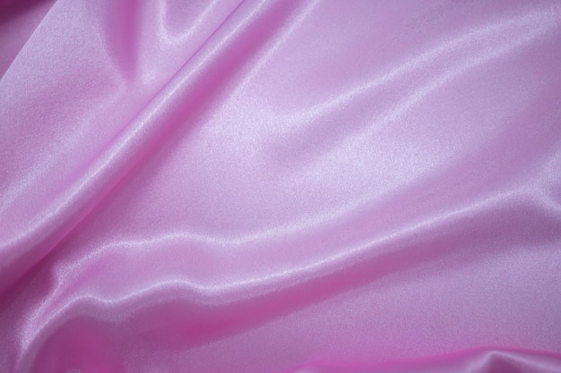 Abstract pink Satin Silky Cloth Fabric Textile Drape with Crease Wavy Folds background