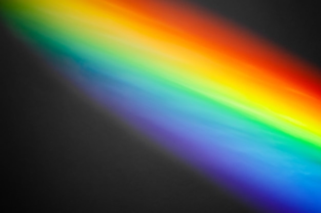 Abstract rainbow rays daylight on black background