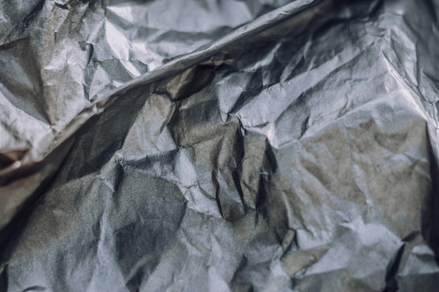 Abstract real paper surface background Aluminum Platinum Silver foil Wrinkled crumpled folds bend crush crease kink Crystal polygonal texture wave futurism 80s retro style new year Gray tone