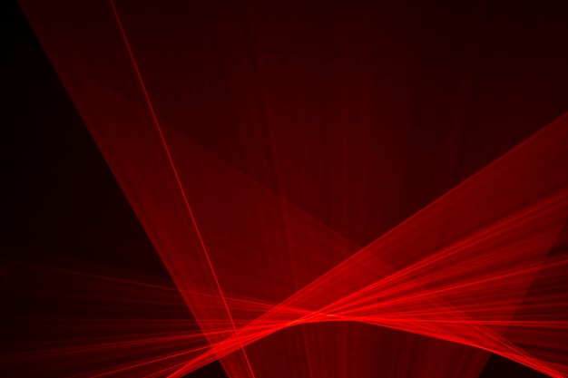 Abstract red lines drawn by light on a black background. Laser lines