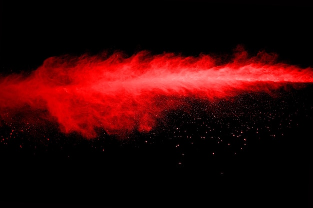 Abstract red powder splatted on black background