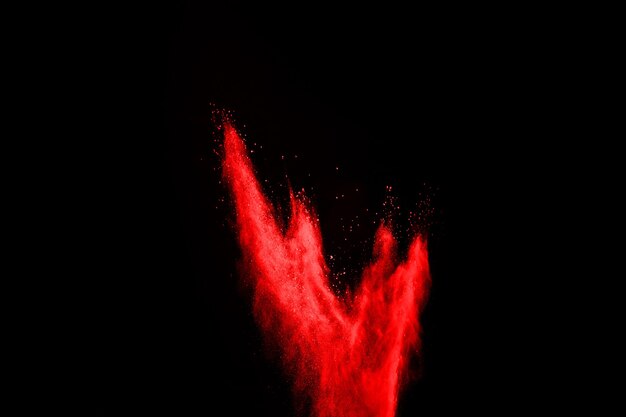 Abstract red powder splatted on black background