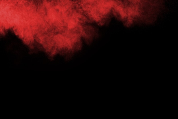 abstract red powder splatted on black background.  