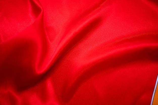 Abstract Red Satin Silky Cloth Fabric Textile Drape with Crease Wavy Folds background