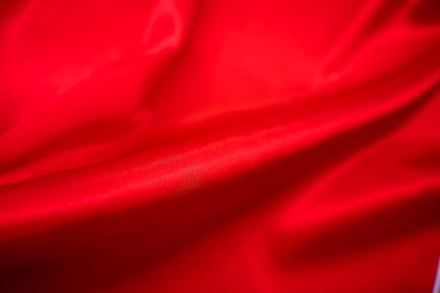 Abstract Red Satin Silky Cloth Fabric Textile Drape with Crease Wavy Folds background