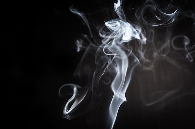 Abstract smoke swirls on black background