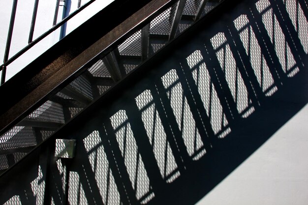 Abstract steel structure in black iron stairs with shadow on the wall