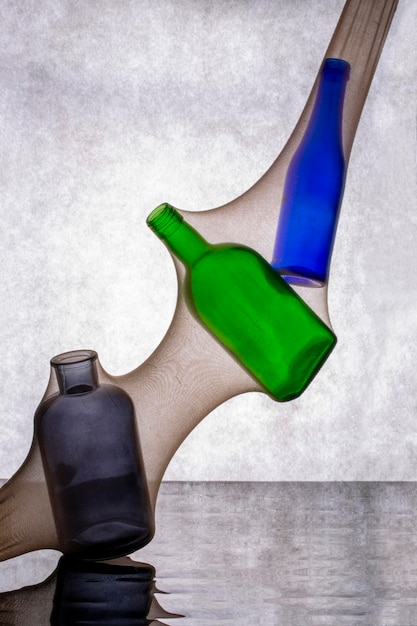 Abstract still life with colored bottles in women's tights