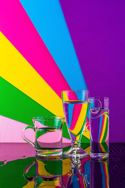 Photo abstract still life with a glasses of water on a color bright background