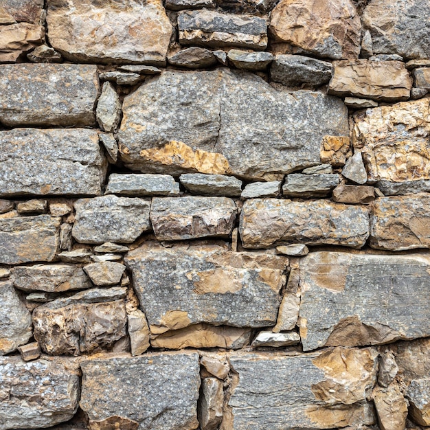 Фото Абстрактное изображение фона каменной стены отлично подходит для использования в качестве фона
