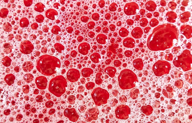 Abstract structure of red foamed surface of liquid Lowdepth background image