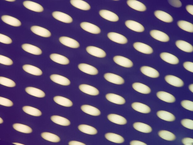 Abstract sun bunnies dots and ovals Purple lilac and white trendy ugly Retro disco style Abstract background with different blurred sun glare passing through the holes of the blinds or shutters