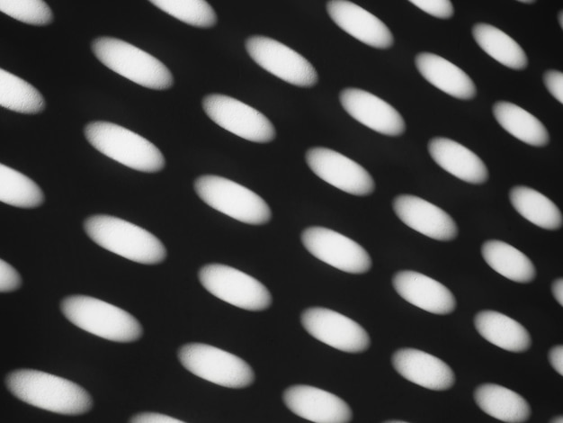 Abstract sun bunnies ovals Black and white trendy ugly Retro or disco style Abstract background with different blurred sun glare passing through the holes of the blinds or shutters