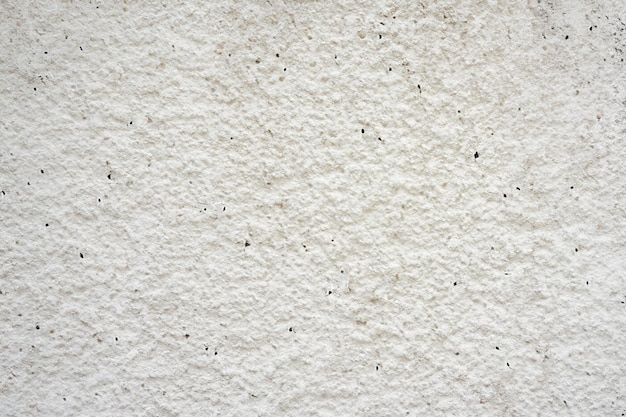 白いコンクリートの石の壁の抽象的な表面と質感