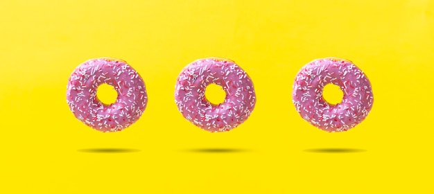 The abstract sweet delicious donut isolated on color background