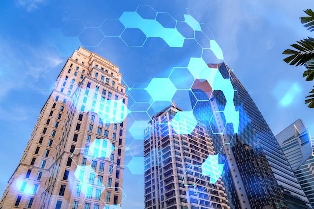 写真 金融のダウンタウンのガラスと鋼の現代的な超高層ビルの低広角ビューの抽象的な技術アイコンホログラムハイテク業界での成功の概念二重露光