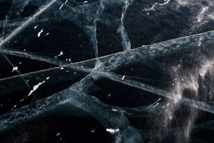 Photo abstract texture. the ice cracked on the baikal lake