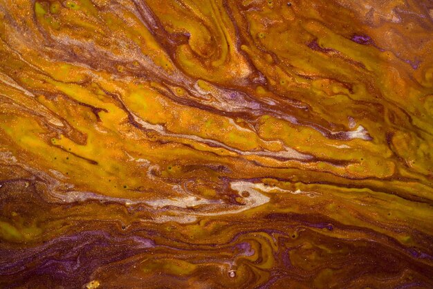 Abstract texture of mixed paints in hot yellow tones Marble texture of stone