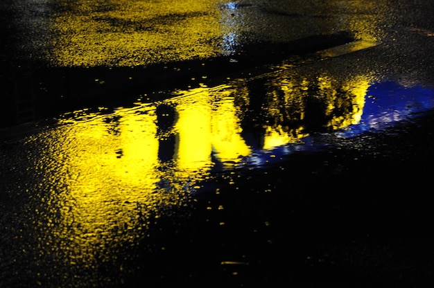 Abstract urban history, Lights and shadows, streets after rain with reflections on wet asphalt., horizontal image with blurred background, free space for text, defocus blurred