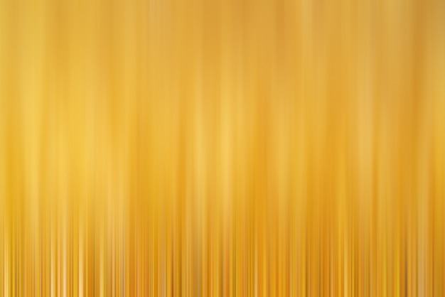 Abstract vertical yellow lines background. Streaks are blurry in motion.