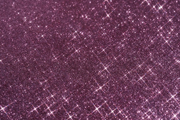 Photo abstract violet background with sparkles in the shape of stars