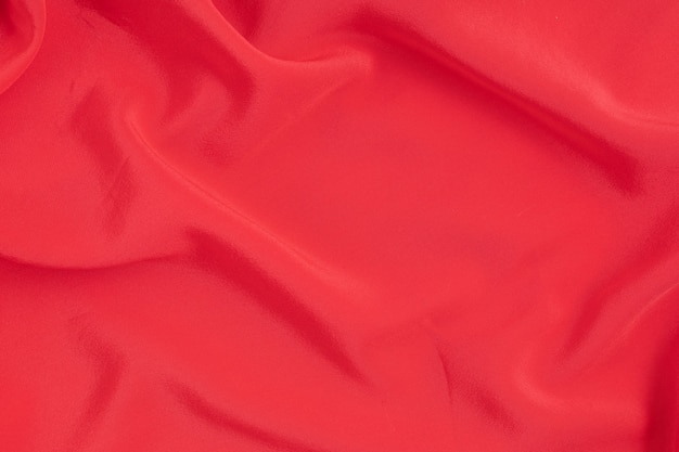 赤い絹の布の抽象的な壁。テクスチャ、ラグジュアリー、ファッション、スタイルのアイデア