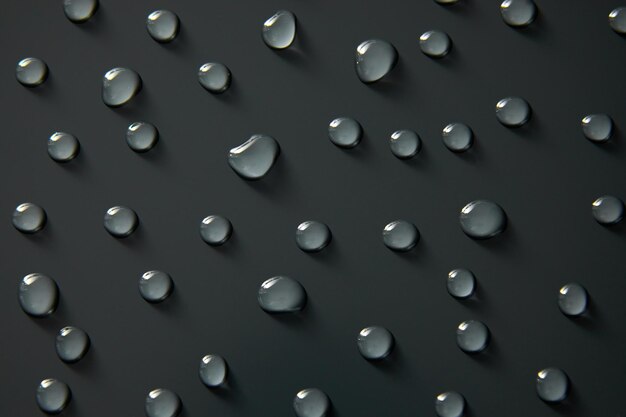 Photo abstract water drops on grey background macro bubbles close up cosmetic moisturizing liquid drops flat lay pattern