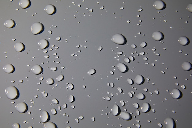 Abstract water drops on grey background macro Bubbles close up