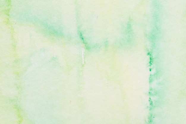 Photo abstract watercolor background spots and stains of green paint on paper