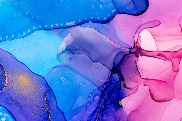 ゴールドスポットと抽象的な水彩画の青とピンクのグラデーションの背景
