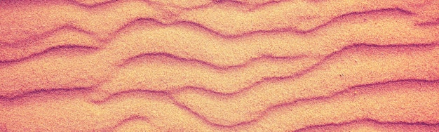 Abstract wavy sandy background Texture of sand in desert or on the beach Horizontal banner