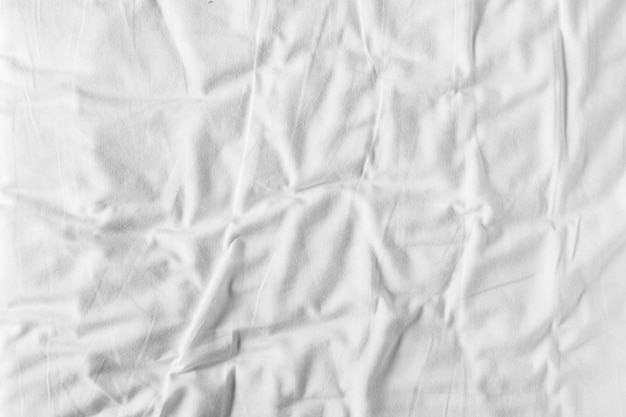 Photo abstract white bedding sheets or white wrinkled fabric background texture and texture with copyspace creased or wrinkled white fabricsoft focus