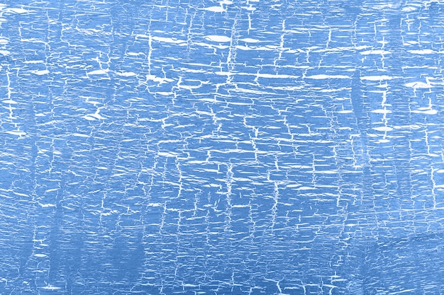 Abstract white and blue painted cracked wall