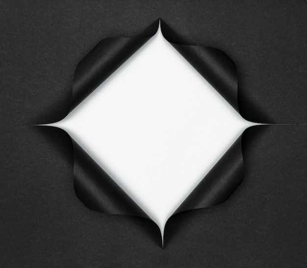 Photo abstract white shape on torn black paper