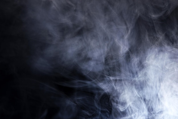 Abstract white smoke moves on black background Beautiful swirling gray smoke