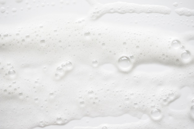 Photo abstract white soapy foam texture. shampoo foam with bubbles