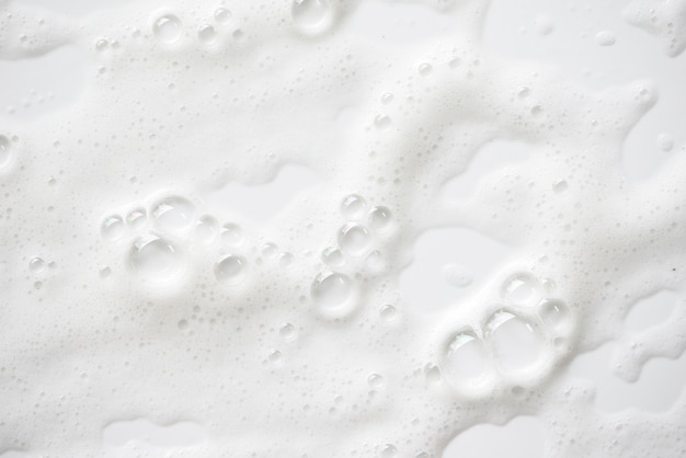 Фото Абстрактная белая мыльная текстура пены. шампунь-пена с пузырьками