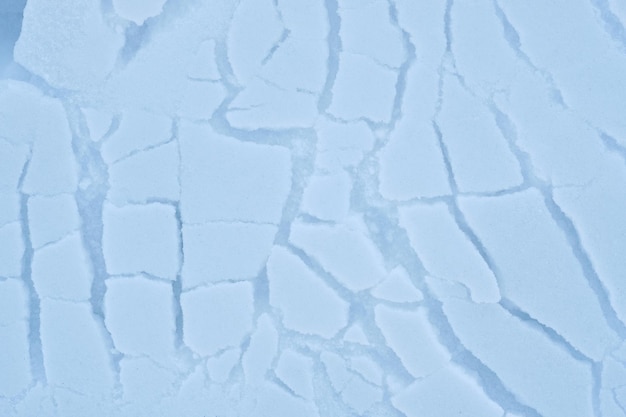 Abstract winter background texture of cracked snow