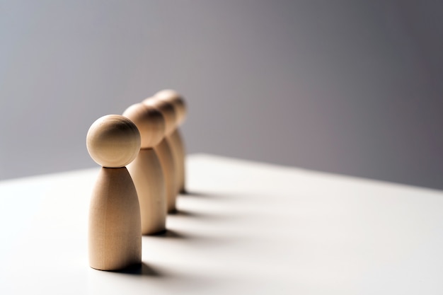 Abstract wooden toy figures stand in a row