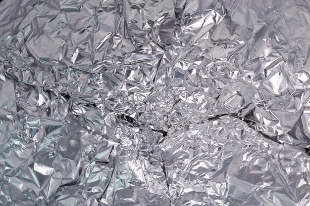 Abstract wrinkled aluminum foil closeup full frame background