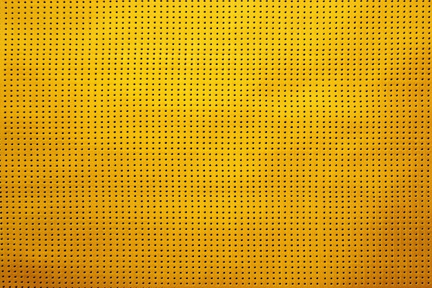 Abstract yellow background with small holes pattern of small holes