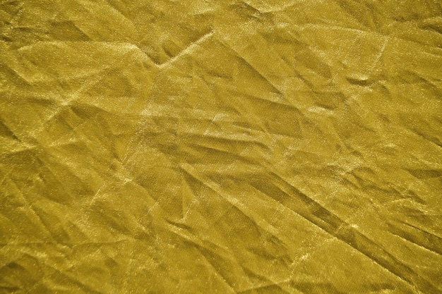 Abstract yellow gold background crumpled fabric