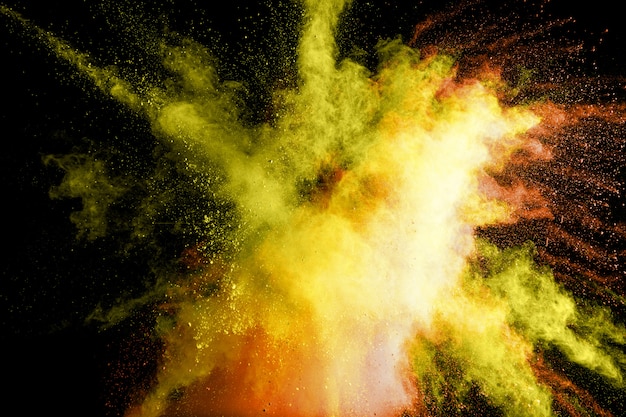 Abstract yellow powder explosion. Freeze motion of yellow dust splash.