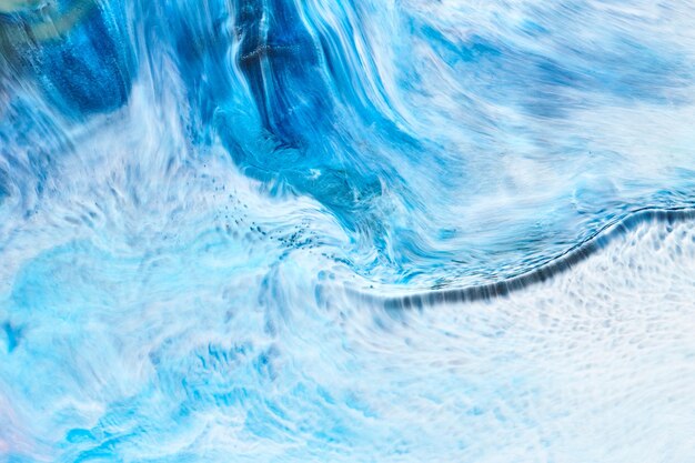 Abstracte blauwe achtergrondkleur Veelkleurige vloeibare kunst Golven spatten en vlekken acrylalcoholinkt verven onder water