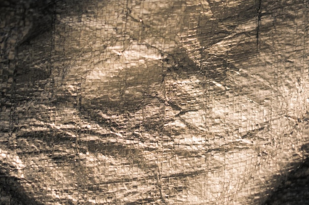 Abstracte echte stof oppervlakteachtergrond Aluminium Platina Zilverfolie Dekzeileffect met ruwe textuur jute rand Futurisme 80s retro-stijl nieuwjaar Donkergrijs bruin toonontwerp Meer op voorraad