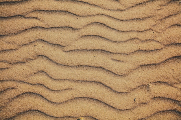 Abstracte golvende zandige achtergrond Strandzandtextuur
