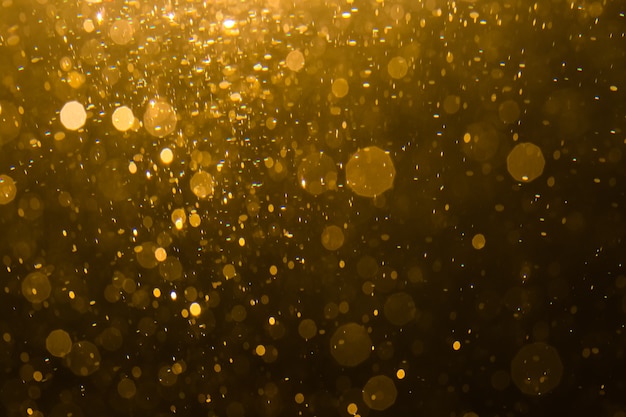 Abstracte gouden bokeh met zwarte achtergrond