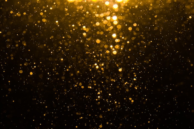 Abstracte gouden bokeh met zwarte achtergrond